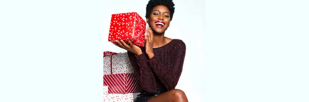 Woman holding a present and smiling